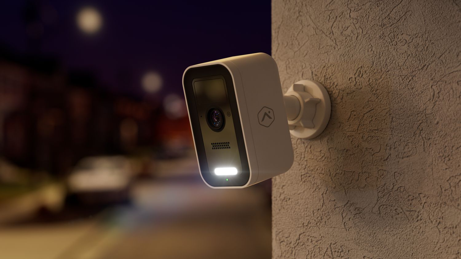 Alarm.com V731B battery camera lighting a walkway at night