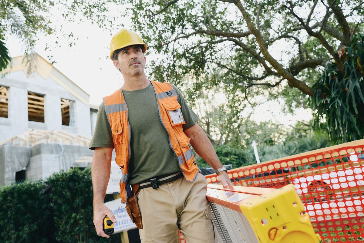 Construction worker on site with an Indigo device clipped to his belt